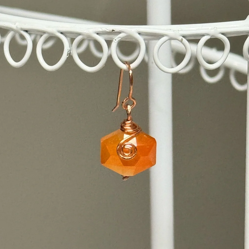 Copper Wire-Wrapped Orange Faceted Hexagon Earrings.